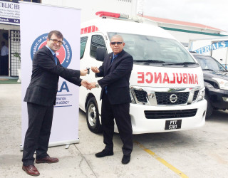 Associate Professor of International Relations and Director of South America of TIKA, Mehmet Ozkan (left) hands over the keys to the ambulances to Public Health Minister, Dr. George Norton (Ministry of Public Health photo) 