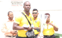 Guyana Jaguars assistant head Rayon Griffith poses with the Regional Four Day trophy yesterday prior to the team’s departure for Antigua.
