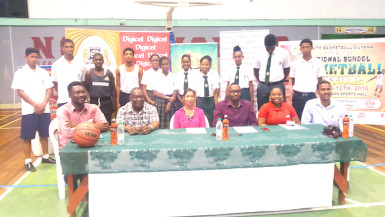 Members of the launch party for the 11th National Schools Basketball Festival Regional Conference Championships posing for a photo opportunity with students from the participating schools at the Cliff Anderson Sports Hall 