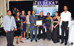 Minister of Public Health, Dr. George Norton and CEO of Eureka Medical Lab (centre) W. Andrew Boyle flanked by others as they display the ISO accreditation certificate.  