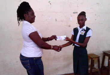 Winner of the first ever Linden youth business challenge Dacia Hamilton (right) collecting her winnings.