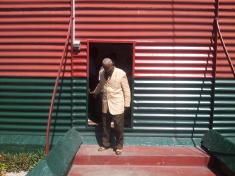 Chairman of the Commission of Inquiry Justice James Patterson exits the Camp Street prison after a Commission visit to the facility. (Photo by Keno George) 