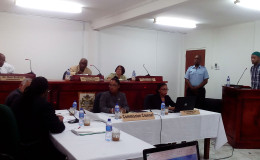 Michael Lewis, the fourth prisoner to testify at the CoI into the prison unrest, at the witness stand. Seated at rear (from left) are: Commissioner Dale Erskine, Chairman of the Commission of Inquiry Justice James Patterson and Commissioner Merle Mendonca. From left (at front) are: Representative of the Guyana Prison Service and the Guyana Police Force Selwyn Pieters; President of the Bar Association Christopher Ram; Commission Counsel Excellence Dazzell; and Commission Secretary Teshanna Cox. (Photo by Keno George)
