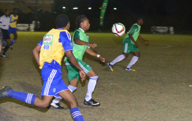 Job Caesar (centre) of Chase Academy trying to control the ball while being challenged by a South Ruimveldt player during their semi-final affair in the 4th Annual Milo Schools u-20 Football Championship. 