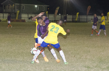 Jamal Codrington (centre) of Fruta Conquerors battling to maintain possession of the ball while being challenged by two Pele players during their matchup in the GFF Elite League at the Tucville ground. (Orlando Charles photo)