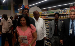 Finance Minister Winston Jordan (centre) with Minister of Public Security Khemraj Ramjattan and his wife Sita (at left) during a tour of the supermarket yesterday in the company of Massy Group officials
