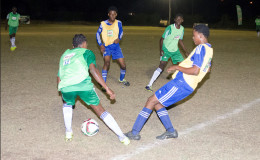 Part of the semi-final action in the 4th Annual Milo Schools u-20 Football Championship between Chase Academy (green) and South Ruimveldt at the Ministry of Education ground.