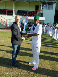 Guyana Jaguars Captain Leon Johnson accepts his trophy from Richard Pybus