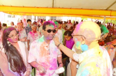 President David Granger (right) greeting former attorney general Anil Nandlall and his wife Hissaun. (Ministry of the Presidency photo) 