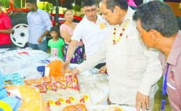 Prime Minister Moses Nagamootoo (second from right) examining some of the items at the exhibition. (Office of the Prime Minister photo)
