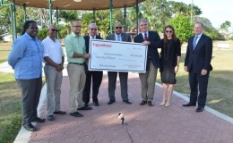 Erik Oswald (third from right), Vice President, Americas, ExxonMobil Exploration Company symbolically presents the $20M cheque to Minister of Natural Resources Raphael Trotman (fourth from right) and Commissioner of Protected Areas Commission, Damian Fernandes (third from left). Also in photo are other ExxonMobil officials and natural resources stakeholders. (GINA photo)