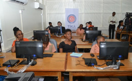 Students, teachers and Turkish officials sitting at computer lab of the Enterprise Primary School, D’urban Backlands  (GINA photo)