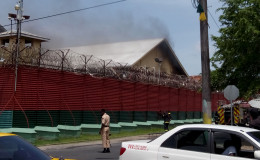 Smoke emanating from one of the buildings in the Camp Street prison today, where nine fires were set.