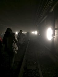 Passengers walk on underground metro tracks to be evacuated after an explosion at Maelbeek train station in Brussels, Belgium, March 22, 2016. REUTERS/Courtesy @OSOSXE via Twitter/Handout via Reuters 