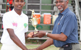 Sagar Hatheramani collects his MVP trophy from match referee Grantley Culbard.