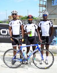  TGE’s Orville Hinds (centre, posing with a Powerade), Marlon Williams (left) and Akeem Wilkinson swept the podium places in yesterday’s 33-mile road race. The team has won 10 of the 13 races staged this season. (Orlando Charles photo) 