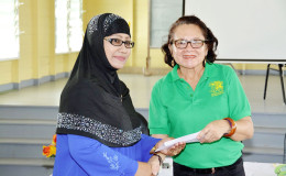 First Lady,  Sandra Granger presenting Latchmin Azeez with a letter of approval for a grant for the Bushlot-Armadale Women’s Group (Ministry of the Presidency photo)