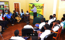 Former Guyana and West Indies skipper Roger Harper speaks with the young cricketers during yesterday’s United Nation’s Day of Sports for the Development of Peace seminar held at the Ministry of Culture, Youth and Sports.
