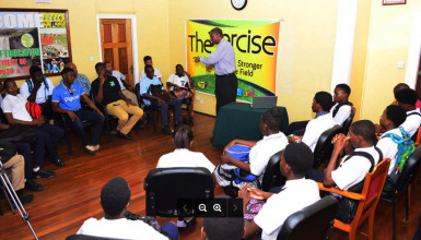 Former Guyana and West Indies skipper Roger Harper speaks with the young cricketers during yesterday’s United Nation’s Day of Sports for the Development of Peace seminar held at the Ministry of Culture, Youth and Sports. 