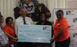 Minister of Tourism and Telecommunications Cathy Hughes (second right) receives the cheque from staff of GTT, including Public Relations Officer Allison Parker (right).