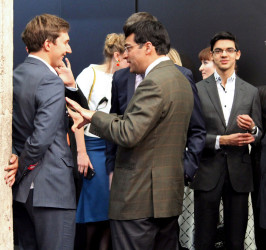  India’s Vishy Anand (centre, backing camera) seems to be making some suggestions to Russia’s Sergey Karjakin (left) during the closing ceremony of the Candidates Tournament. Anand engaged world champion Magnus Carlsen twice for the title. At right is Dutch grandmaster Anish Giri.
