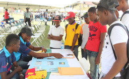 Youth gathering information from one of the booths