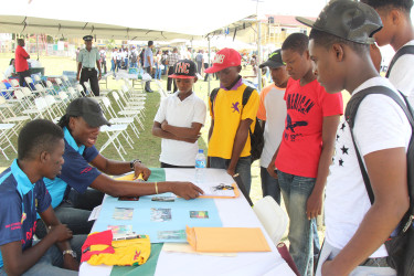 Youth gathering information from one of the booths