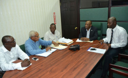 Minister of State Joseph Harmon (second from right)  meeting with the Board of Inquiry