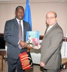 Barbados Minister of Industry Donville Innis exchanging gifts with Cuban envoy Francisco Fernandez Pena in Bridgetown recently. 