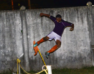 Eon Alleyne of Fruta Conquerors kicking the corner flag in celebration after netting the go-ahead winner against Buxton United in the GFF Stag Beer Elite League. (Orlando Charles photo) 