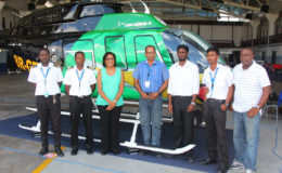 Telecommunications and Tourism Minister Cathy Hughes (third, left) poses with Maintenance Manager Tularam Ramsukh (centre) and the team of ASL engineers who worked on the rebranded aircraft.