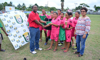 University of Guyana Challus McLennon handing over the Football Uniforms to Piaomak Warriors team in the presence of Minister within the Ministry of Indigenous Peoples Valerie Garrido-Lowe following the conclusion of the NAWF women’s Championships yesterday. (Orlando Charles photo) 