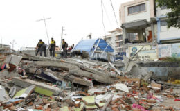 Police officers stand on debris after an earthquake struck off Ecuador’s Pacific coast, at Tarqui neighbourhood in Manta April 17, 2016. REUTERS/Guillermo Granja