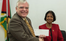 High Commissioner of Canada Pierre Giroux handing over the cheque to Chairperson of the W&GEC Indra Chandarpal
