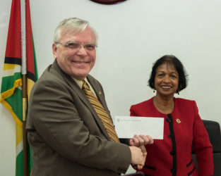High Commissioner of Canada Pierre Giroux handing over the cheque to Chairperson of the W&GEC Indra Chandarpal 