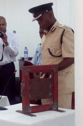 Deputy Director of Prisons Gladwin Samuels demonstrating to the tribunal how the locks at the prisons operate.