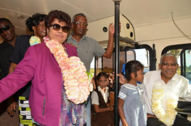President David Granger gets a feel of the driver’s seat while Minister of Social Cohesion Amna Ally (first, left), Region Four Chair Genevieve Allen (background) and Peter Lewis (centre) look on.  (Ministry of the Presidency photo)