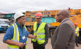 Muneshwers’ Country Manager Robin Muneshwer (left), in talks with Minister of Natural Resources Raphael Trotman (right) and Minister of Business Dominic Gaskin yesterday.
