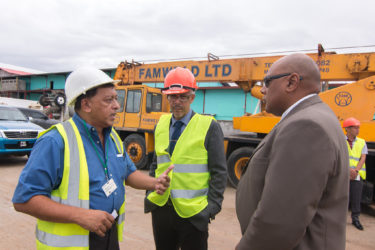 Muneshwers’ Country Manager Robin Muneshwer (left), in talks with Minister of Natural Resources Raphael Trotman (right) and Minister of Business Dominic Gaskin yesterday.   