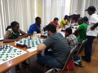 Student of St Stanislaus College Jessica Callender opposes Roberto Neto in the ECI’s chess tournament last Sunday at the National Resource Centre. Callender is becoming a staple at the Guyana Chess Federation’s competitions and has been steadily improving her expertise in the game. Former student of Saints, Ron Motilall, coaches chess at the college on Fridays after classes. (Photo by Ryan Singh)