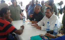 Prime Minister Moses Nagamootoo (seated, right) reacts as he listens to a resident’s concerns yesterday’s ‘Meet the Public Day’ in Corentyne, Berbice