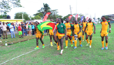 Winners! The national 15s men’s rugby team marches with the Golden Arrowhead following their 48-17 victory over Barbados in the opening game of the 2016 Rugby America’s North 15s championship yesterday at the National Park. (Orlando Charles photo) 