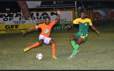 Reshawn Sandiford (left) of Fruta Conquerors trying to evade the impending challenge from Alden Lawrence of the GDF during the matchup at the Tucville Community ground in the GFF Stag Beer Elite League