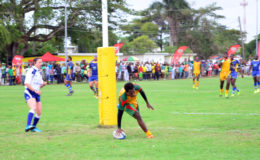 Lance Adonis breaches the try-line of the Bajans to help Guyana record a 48-17 victory over the visitors in the opening game of the 2016 Rugby America’s North 15s championship Saturday at the National Park. (Orlando Charles photo)
