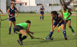 Kerensa Fernandes (blue) of GCC battling for possession of the ball with a Hikers player during their fixture in the inaugural Woodpecker Women’s Hockey League at the GCC ground.