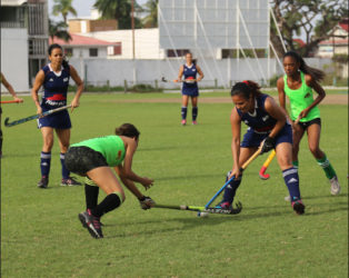 Kerensa Fernandes (blue) of GCC battling for possession of the ball with a Hikers player during their fixture in the inaugural Woodpecker Women’s Hockey League at the GCC ground.