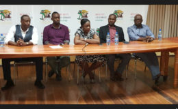 Minister within the Ministry of Education Nicolette Henry (centre) addressing the gathering at the forum while Alex Bunbury (left), NSC Director Christopher Jones (2nd left), GFF President (2nd right) and Sam Bunbury (right) looks on