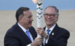 Spyros Capralos, head of the Hellenic Olympic Committee (L), hands over an Olympic torch to Rio’s Olympic chief Carlos Nuzman during the handover ceremony of the Olympic Flame to the delegation of the 2016 Rio Olympics, at the Panathenaic Stadium in Athens, Greece, yesterday..REUTERS/ALKIS KONSTANTINIDIS