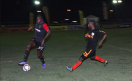 Trayon Bobb (right) of Slingerz FC chasing down Alpha United centre-half Solomon Austin for possession of the ball during their GFF Stag Beer Elite League  matchup at the Camp Ayanganna ground