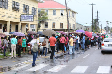 The long line of persons in front of the passport office yesterday.